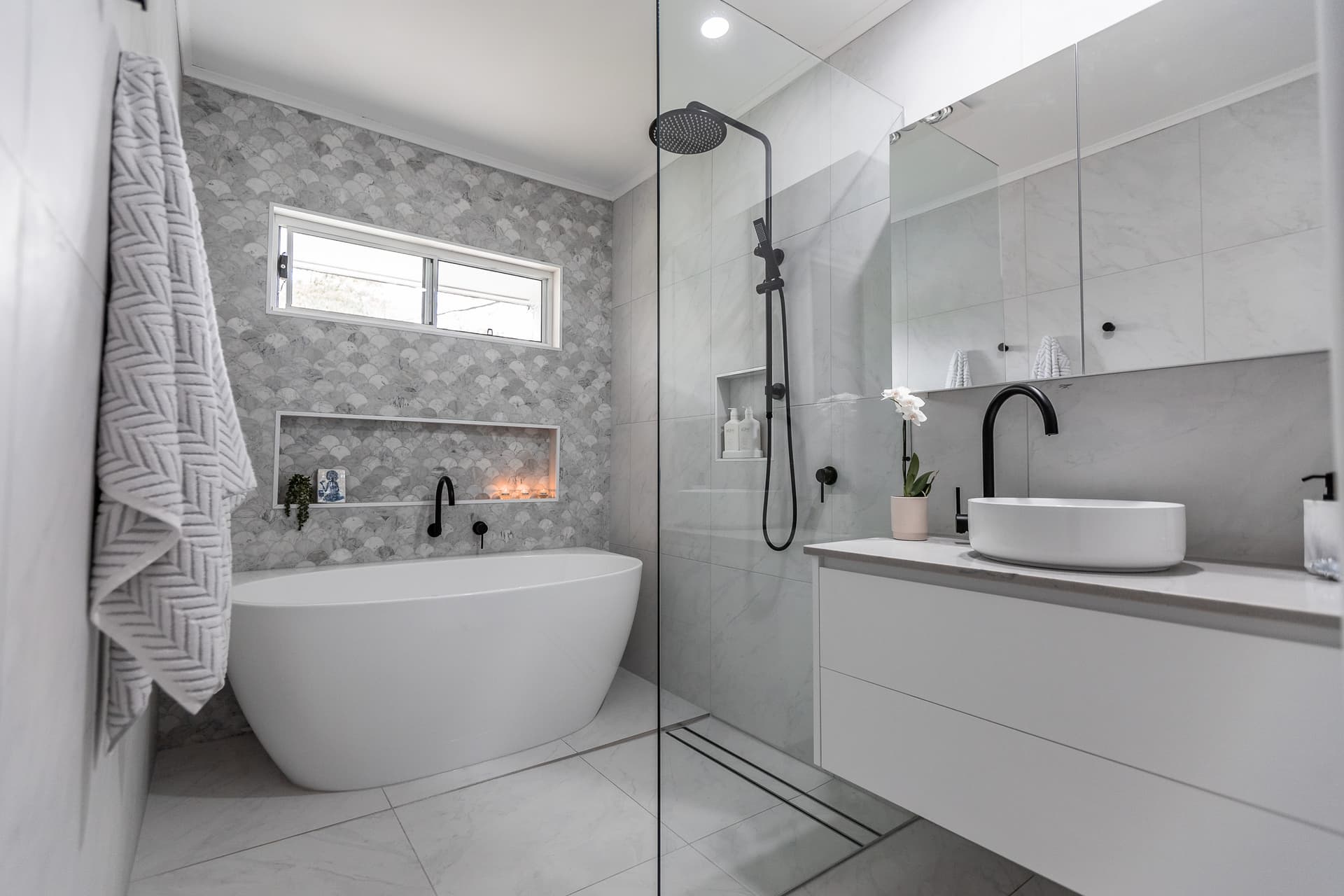 Luxury bathroom renovation in Sydney featuring a freestanding bath, walk-in shower and custom vanity