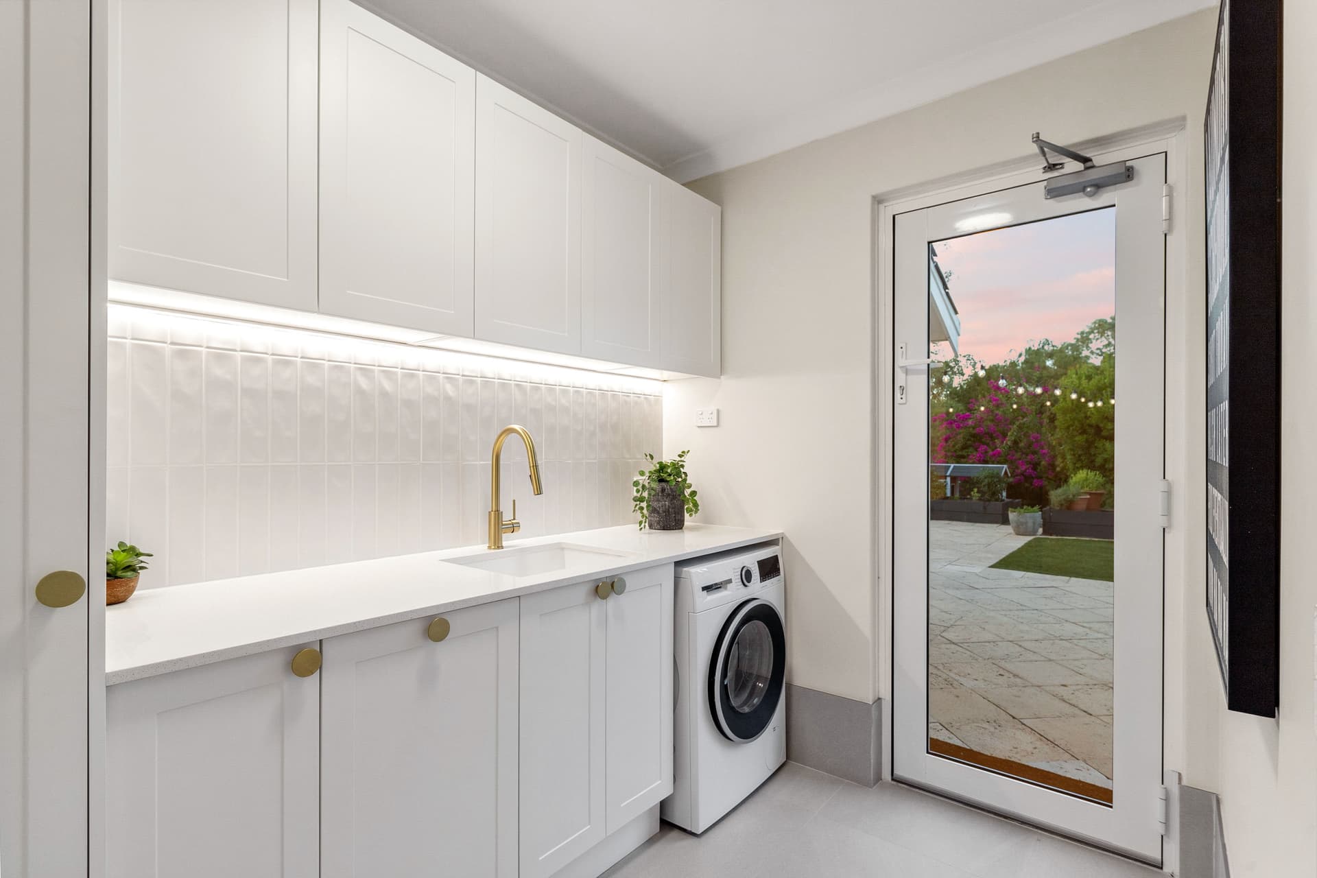 Contemporary laundry renovation with custom cabinetry in Sydney by Artistic Bathroom & Kitchen Renovations